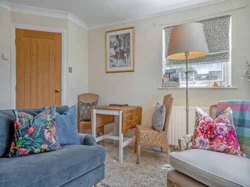 a living room with a couch and a table at Halfehill Cottage in Richmond