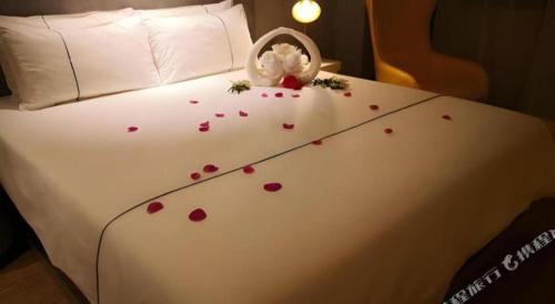 a bed with a bunch of hearts on it at Magnotel Hotel Suzhou Guanqian Street Pingjiang Road in Suzhou