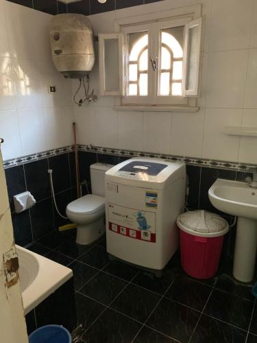 a small bathroom with a toilet and a sink at ELzohor Resort in Alexandria