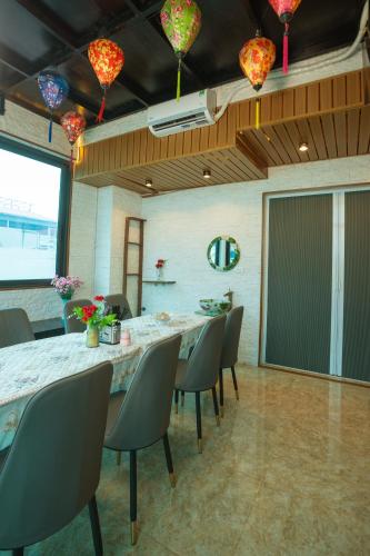 a dining room with a long table and chairs at Atypik Vietnam House in Hanoi