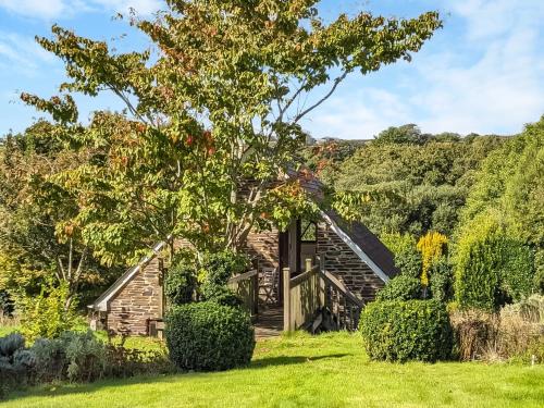 a house in the middle of a yard with a tree at Gwel An Lowarth in Lostwithiel