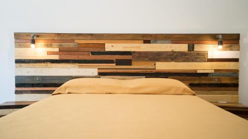 a bedroom with a wall made of wood at Casa della Nonna Polignano a mare in Polignano a Mare