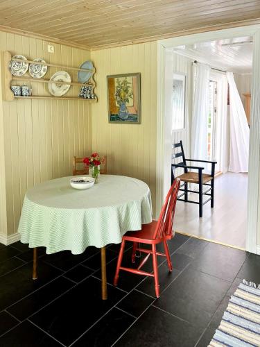 a dining room with a table and two chairs at Cosy Guest House By The Coastal Path In Larkollen in Laurkollen