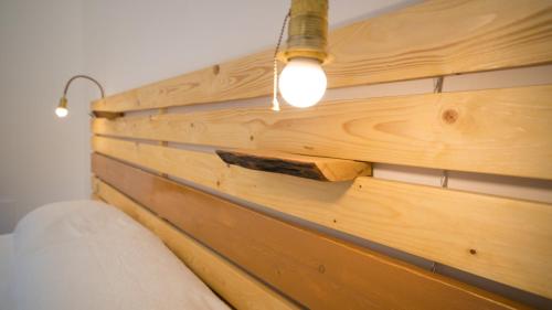 a wooden wall with a light on top of it at Casa della Nonna Polignano a mare in Polignano a Mare