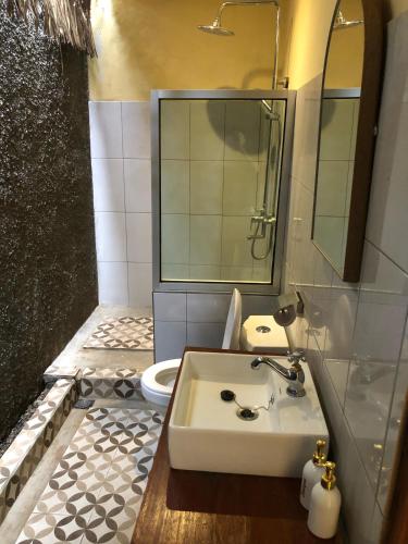 a bathroom with a sink and a toilet at Waroeng Senaru Cottages in Senaru