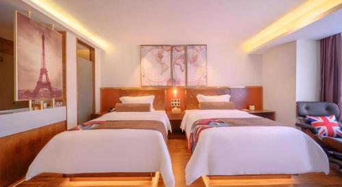 a bedroom with three beds and the eiffel tower at James Joyce Coffetel Wuhan Gutian Er Road Metro Station in Wuhan