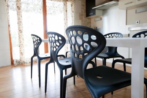 a dining room with black chairs and a table at Domaine de Verchant & Spa - Relais & Châteaux in Montpellier