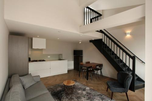 a living room with a couch and a table at Stayci Serviced Apartments Westeinde in The Hague
