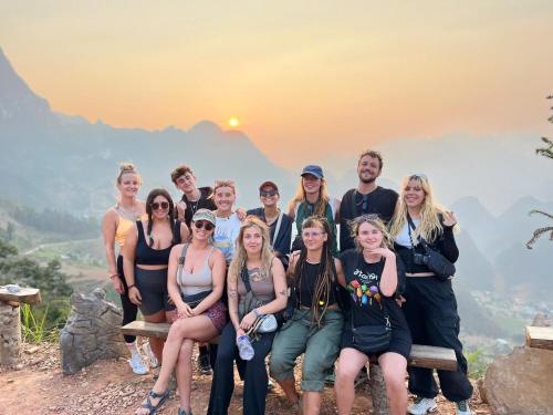 a group of people posing for a picture at the top of a mountain at Rebel Rooster Hostel in Hanoi