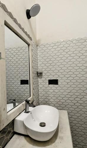 a bathroom with a white toilet and a mirror at The Village - Ella in Bandarawela