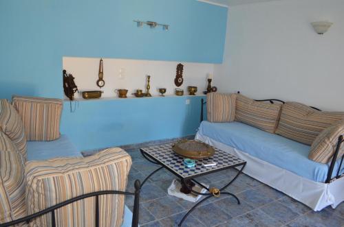 a living room with two couches and a table at Villa Romanza beach villa in Halki