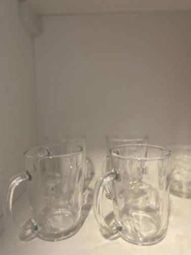 a group of glass mugs sitting on a table at The Suite Room at The Amani Grand in Mactan Cebu International