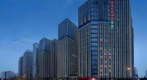 a group of tall buildings in a city at Vienna Hotel Chengdu Exhibition Center In Time City in Chengdu