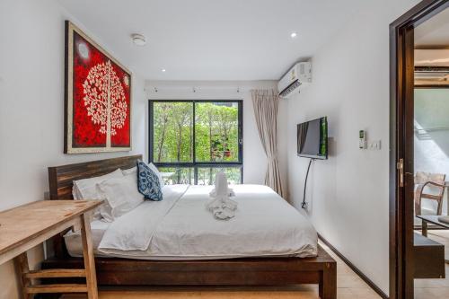 un dormitorio con una cama y una ventana en C218 Cozy Condo Near Top Beaches in South Phuket, en Rawai Beach