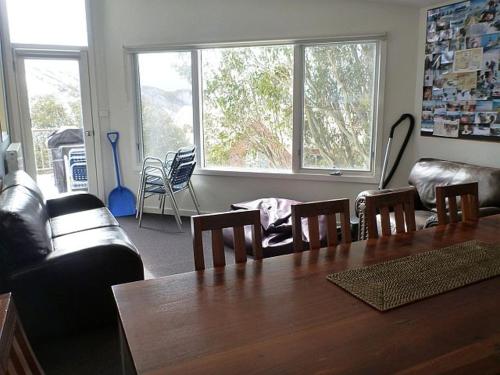 a living room with a wooden table and chairs at Sun Valley Apartment 7 in Falls Creek