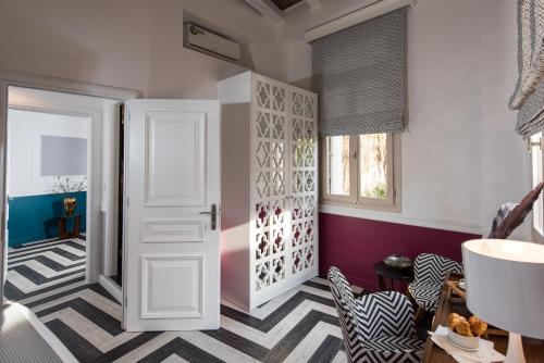 a room with a door and a striped floor at Elia Portou Due in Chania