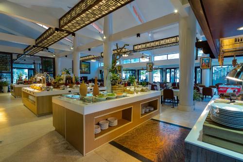 a restaurant with dishes on display in a building at Mercury Phu Quoc Resort & Villas in Phu Quoc