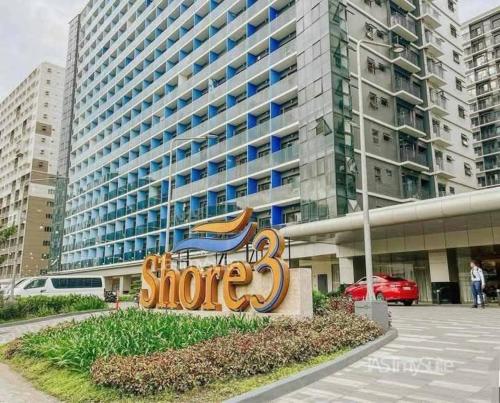 a sign in front of a large building at Mall of Asia gateways shore 3 condotel in Manila