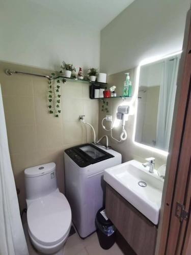 a small bathroom with a toilet and a sink at Mall of Asia gateways shore 3 condotel in Manila