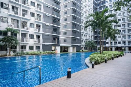 a large swimming pool in front of a building at Mall of Asia gateways shore 3 condotel in Manila