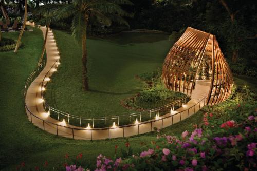 a garden with a building with lights on it at Shangri-La Singapore in Singapore