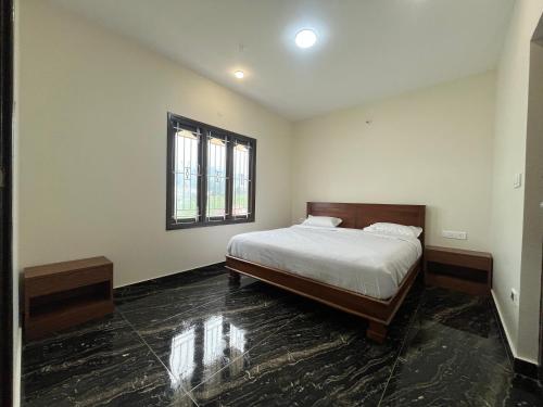 a bedroom with a bed and a window at Away From Home - 8 - HomeStay, Entire 2 BHK Villa in Ooty