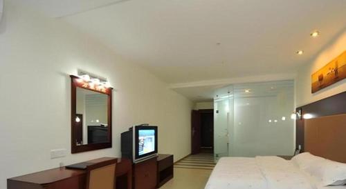 Postel nebo postele na pokoji v ubytování Wanxiang Hotel