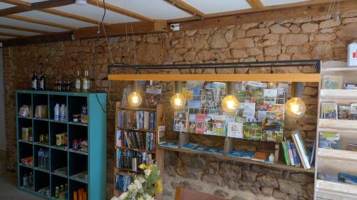 a book store with a stone wall at Séjour nature en tente équipée in Soubrebost