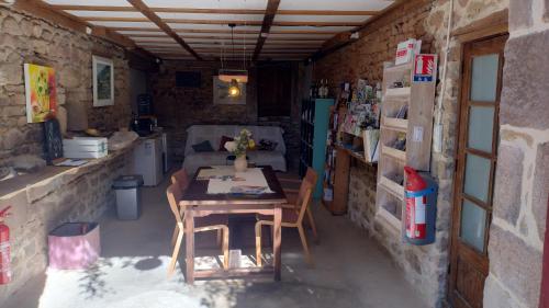 a kitchen with a table and chairs in a room at Séjour nature en tente équipée in Soubrebost