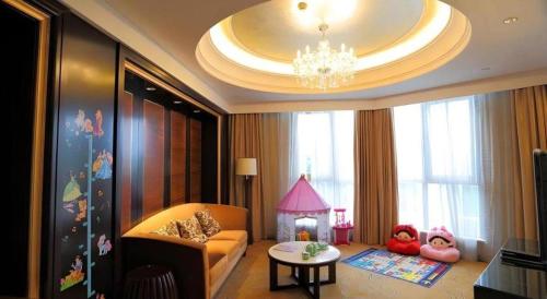 a living room with a couch and a fire place at Royal Tulip Hotel Zhujiajiao Shanghai in Shanghai