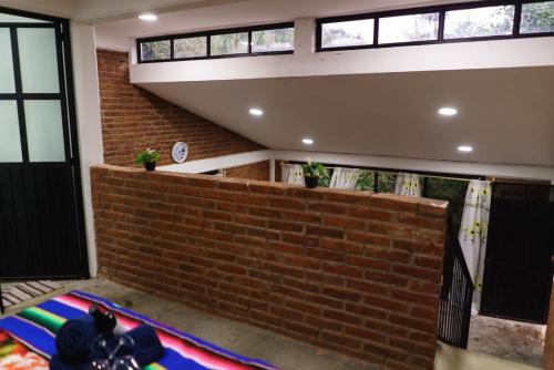 a large rug in a room with a brick wall at Find Your Perfect Mountain Retreat at House Sun 