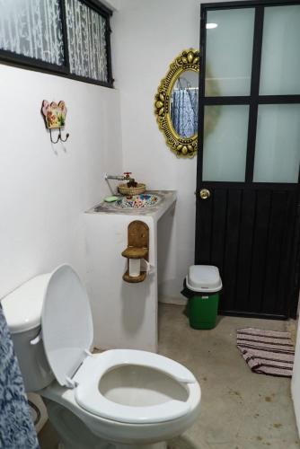 a bathroom with a toilet and a black door at Find Your Perfect Mountain Retreat at House Sun 