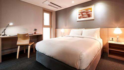 Ένα ή περισσότερα κρεβάτια σε δωμάτιο στο New Raon Stay