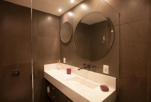 a bathroom with a sink and a mirror at The Place Leblon in Rio de Janeiro