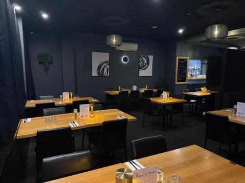 a dining room with wooden tables and chairs at Prince of Wales Hotel in Hobart