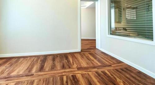 an empty room with wood floors and a window at Galaxy Hotel in Jeju