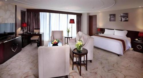 a large hotel room with a bed and a desk at SUN Yat-sen university Hotel and Conference Centre in Guangzhou