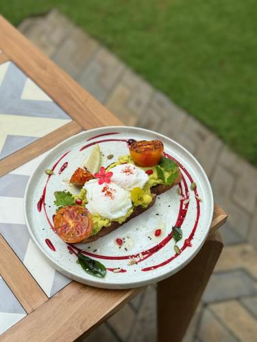 a plate of food with eggs on a table at Rob Roy in Beruwala