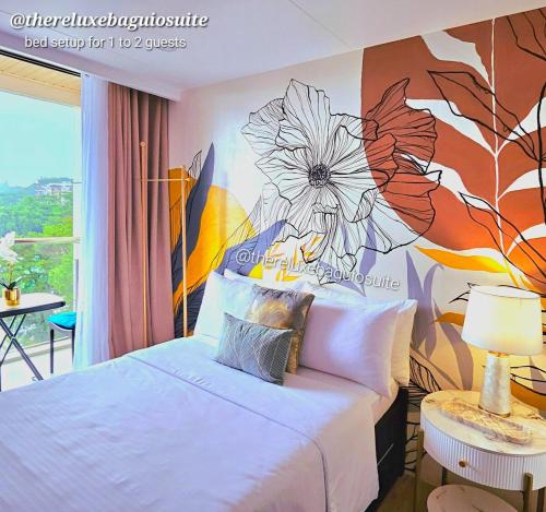 a bedroom with a flower mural on the wall at The ReLuxe Baguio Suite CityHub in Baguio