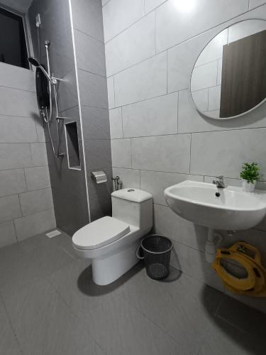 a bathroom with a toilet and a sink at Ainur's Homestay Desaru 2 in Bandar Penawar