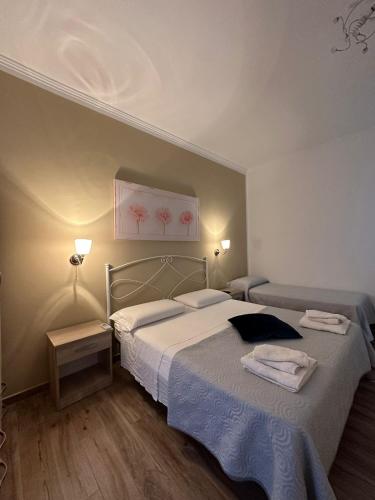 a bedroom with a bed and a painting on the wall at Giardino dei Baroni house in Marina di Mancaversa