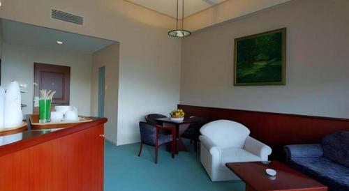 a living room with a couch and a table at Hotel Niagara Parapat in Parapat