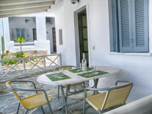 a table and chairs sitting on a patio at Hotel Helena in Ios Chora