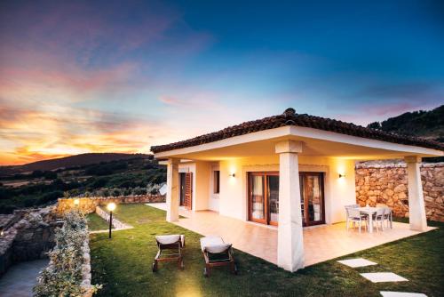 a villa with a view of the sunset at Le Ville Le Saline in Palau