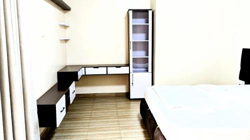 a small room with two beds and a closet at Kigali Star Home in Kigali