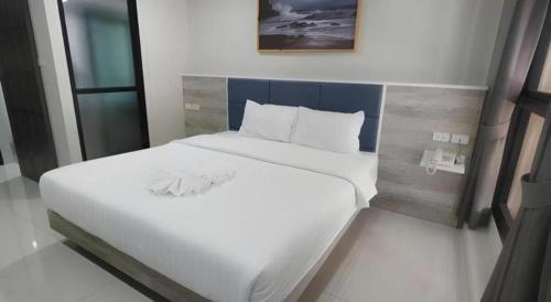 a large white bed in a room at Sattahip 9 Boutique Hotel in Pattaya Central