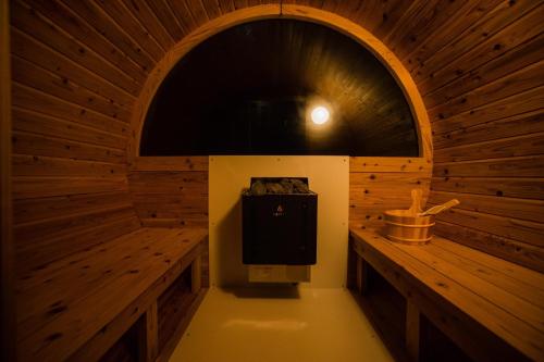 an inside view of a wooden sauna with a tv at Alpha Terrace Motobu Hills in Motobu