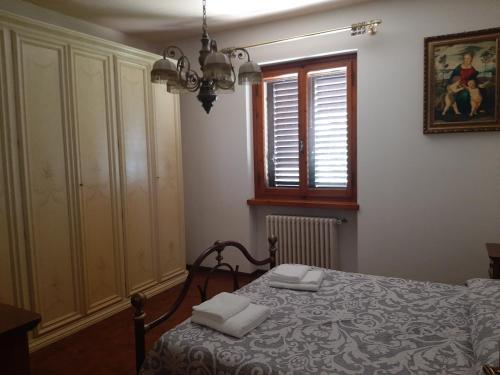 a bedroom with a bed with two towels on it at Villa Azzurra in Arezzo