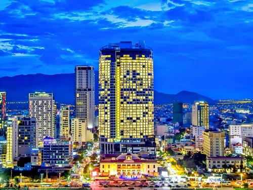 a city skyline at night with a tall building at S79 Residence LYN Panorama in Nha Trang
