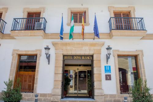 a building with a large window and a clock on the front of it at Hotel Doña Blanca in Jerez de la Frontera
